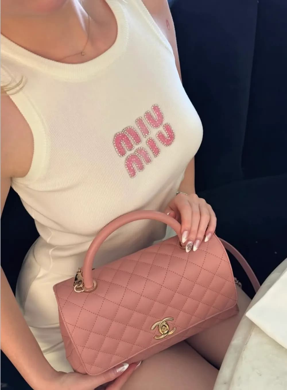 White logo tank with a pink top handle bag
