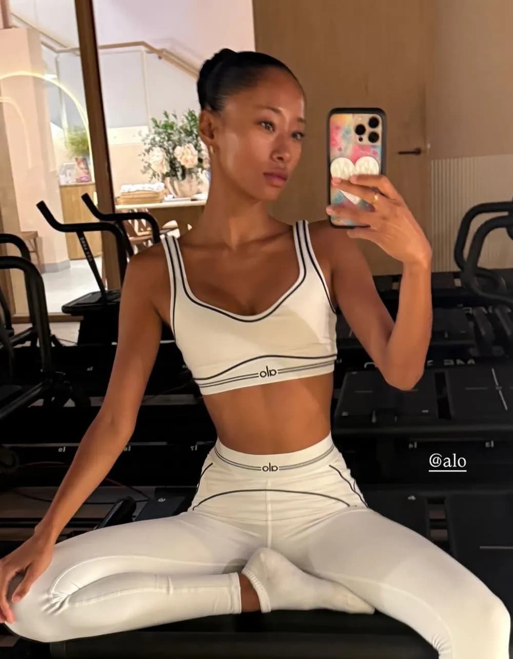 White sports bra and leggings set in the studio